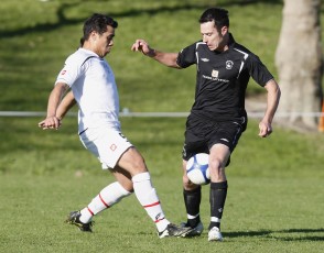 FHM's Kelly Escolme gets tangled up with Ngaruawahia's Mark Norris. NRFL Northern Region Football League Premier Division, Forrest Hill Milford AFC v Ngaruawahia Utd AFC, Becroft Park, Forrest Hill, Saturday 10th July 2010. Photo: Shane Wenzlick
