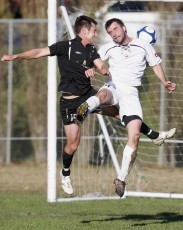 FHM's Kelly Escolme goes up against Ngaruawahia's Mark Phillips. NRFL Northern Region Football League Premier Division, Forrest Hill Milford AFC v Ngaruawahia Utd AFC, Becroft Park, Forrest Hill, Saturday 10th July 2010. Photo: Shane Wenzlick