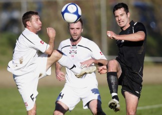 Ngaruawahia's Phill Stables and FHM's Kelly Escolme go after the ball ahead of Ngaruawahia's Mark Phillips (centre). NRFL Northern Region Football League Premier Division, Forrest Hill Milford AFC v Ngaruawahia Utd AFC, Becroft Park, Forrest Hill, Saturday 10th July 2010. Photo: Shane Wenzlick