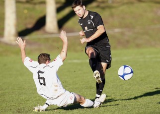 Ngaruawahia's Phill Stables goes in for the tackle on FHM's Chris Bale. NRFL Northern Region Football League Premier Division, Forrest Hill Milford AFC v Ngaruawahia Utd AFC, Becroft Park, Forrest Hill, Saturday 10th July 2010. Photo: Shane Wenzlick