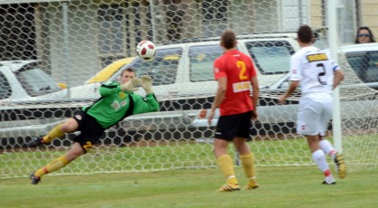 Alex Carr saves a direct free kick from Christchurch's Aaron Clapham.